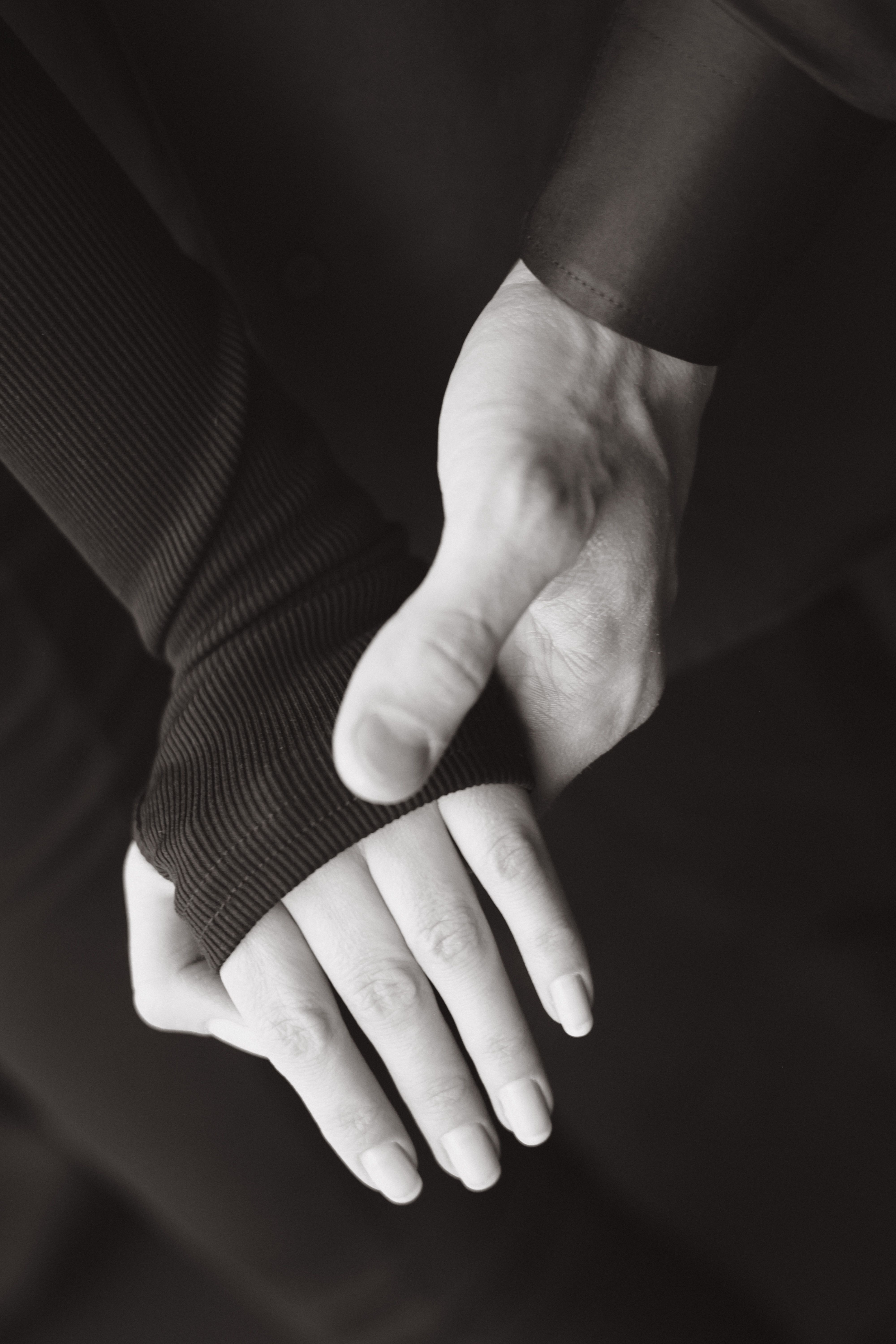 Elegant Black and White Couple Holding Hands · Free Stock Photo