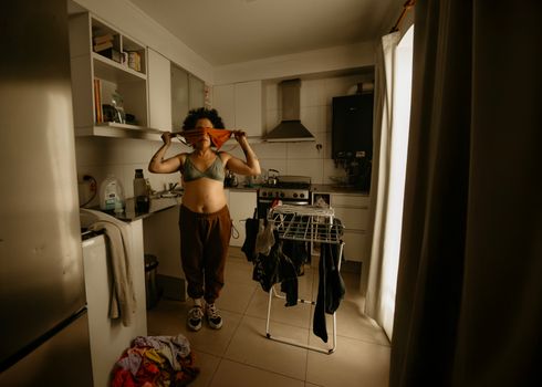 Person enjoying a relaxed morning routine in a warmly lit home kitchen.