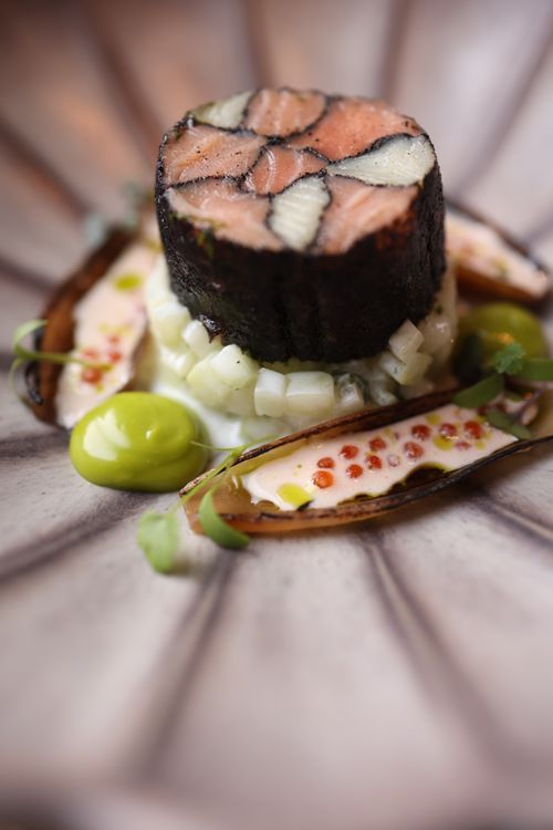 Free Exquisite gourmet sushi dish artfully arranged with vibrant garnishes. Stock Photo