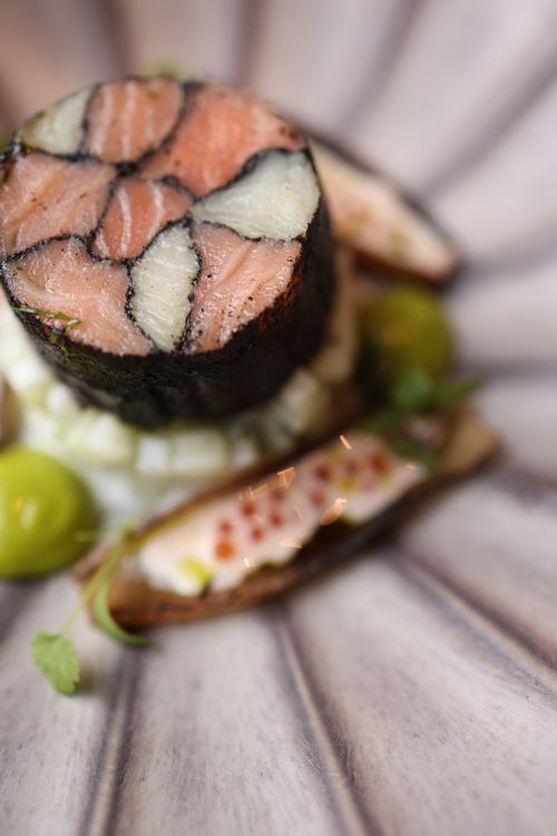 Free Close-up of an artistic gourmet sushi roll with elegant presentation on a decorative plate. Stock Photo