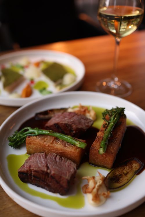 Free Close-up of gourmet steak with vegetables and wine, elegant dining setup. Stock Photo