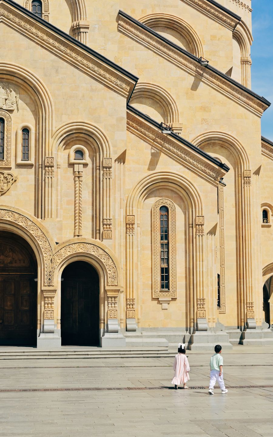 Children walking near Sameba Cathedral in Tbilisi, Georgia
