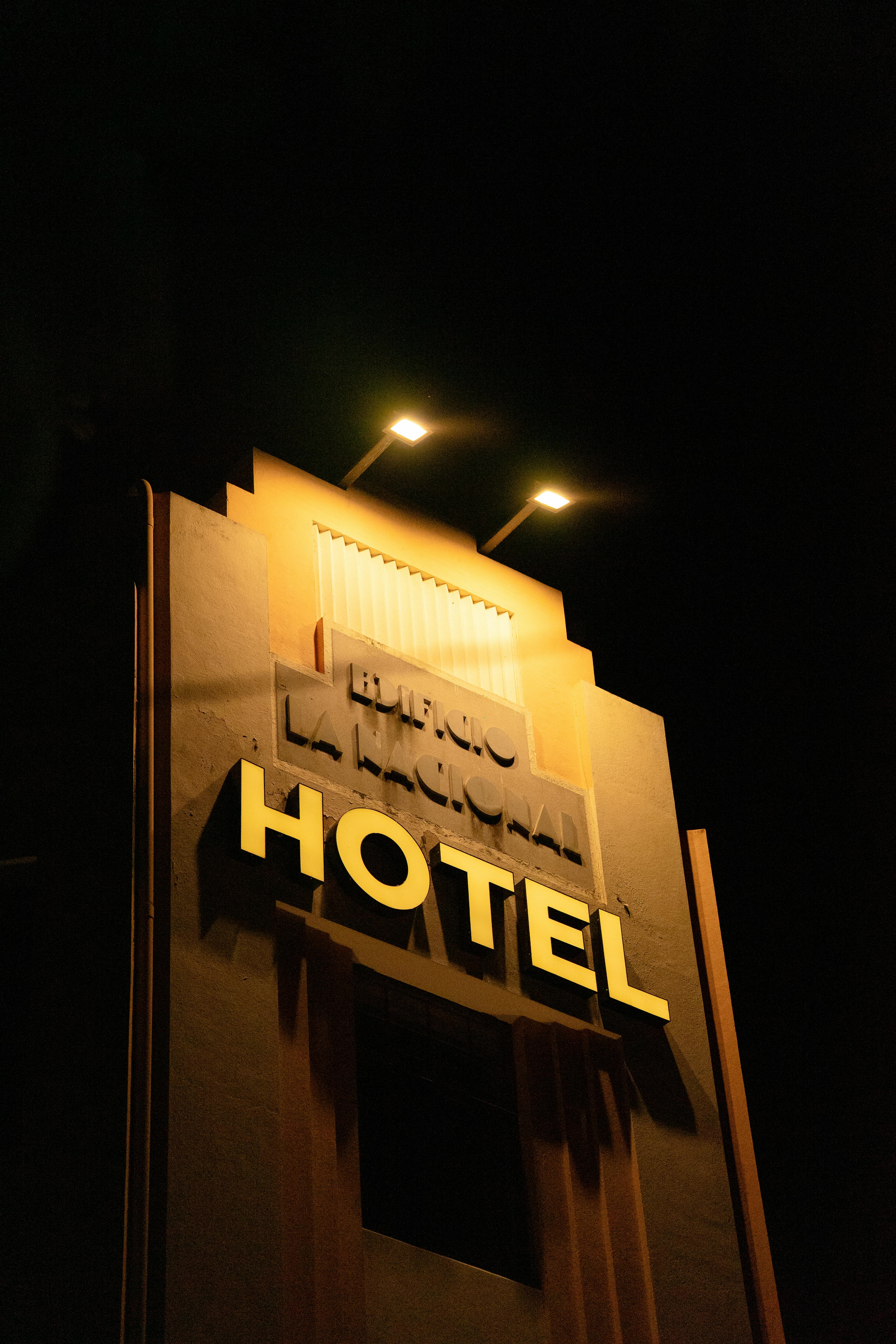 Free A striking image of a hotel sign glowing against the night sky in Merida, Mexico. Stock Photo