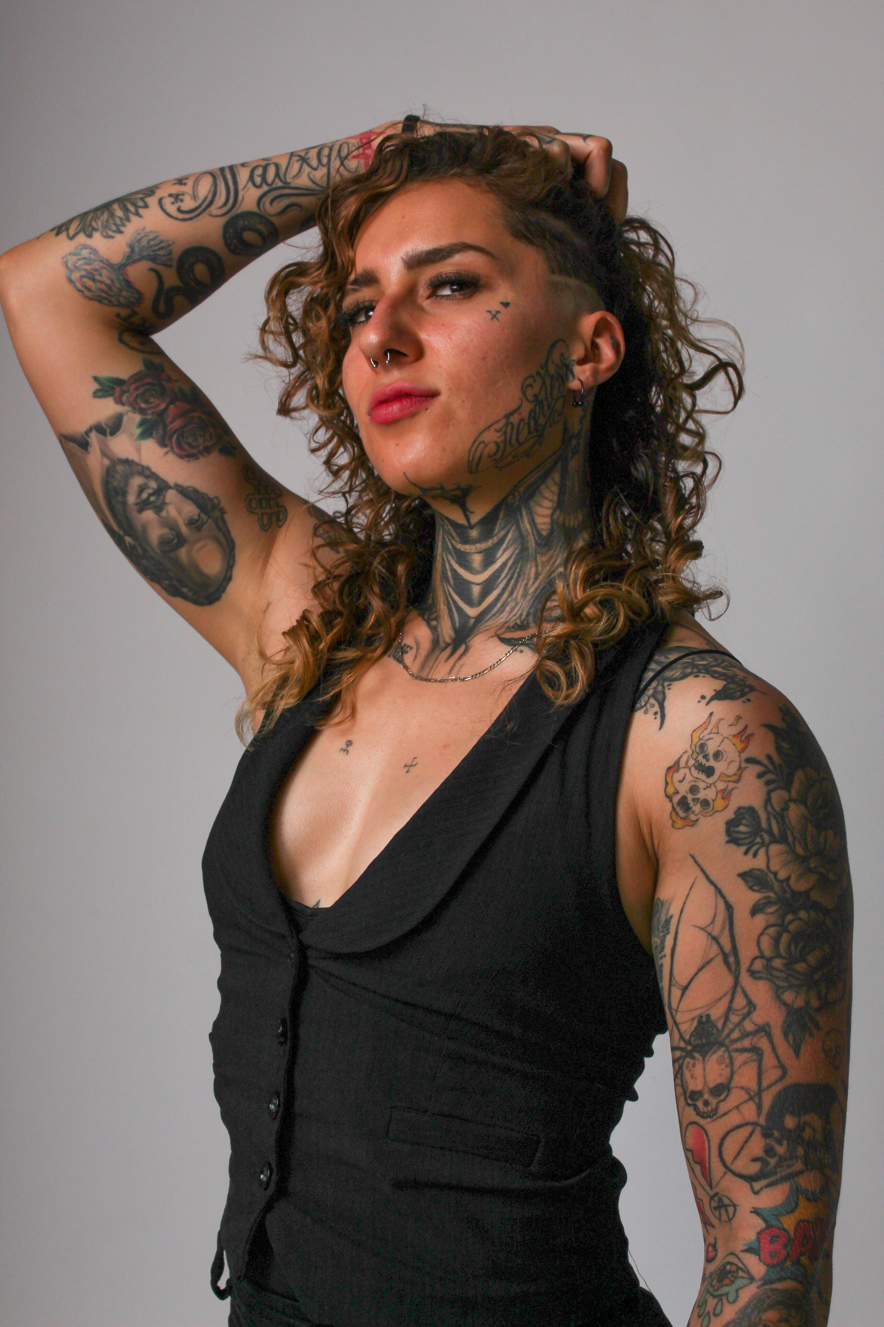 Expressive Portrait of Tattooed Woman in Black · Free Stock Photo