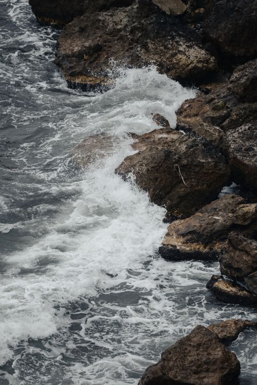 Free Waves crashing against rugged rocks in Ağva, İstanbul, capturing nature's raw power and texture. Stock Photo