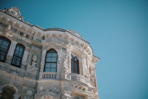 Free Detailed view of ornate Ottoman architectural details against a clear blue sky in İstanbul. Stock Photo