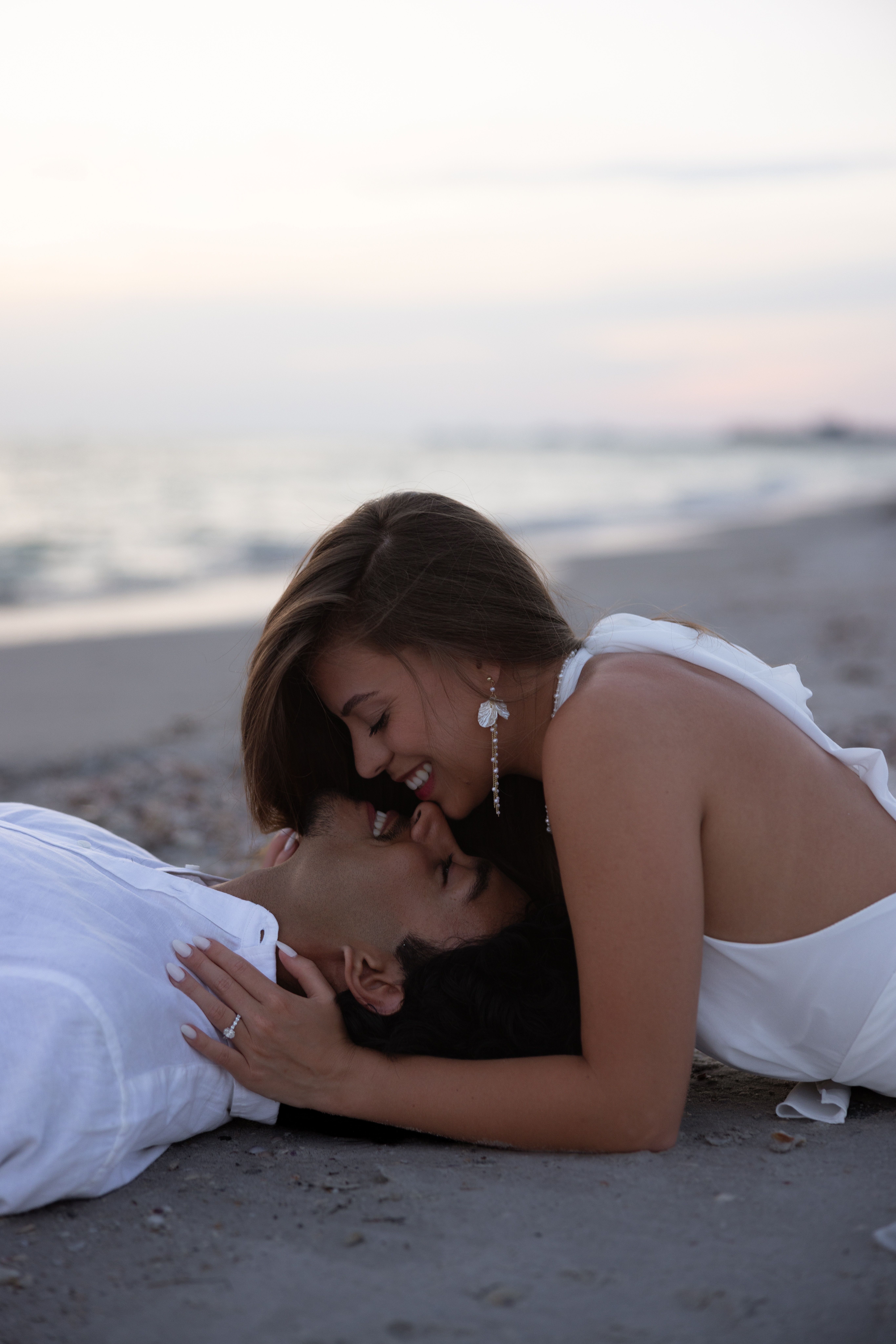Romantic Couple Embracing on a Beach at Sunset · Free Stock Photo