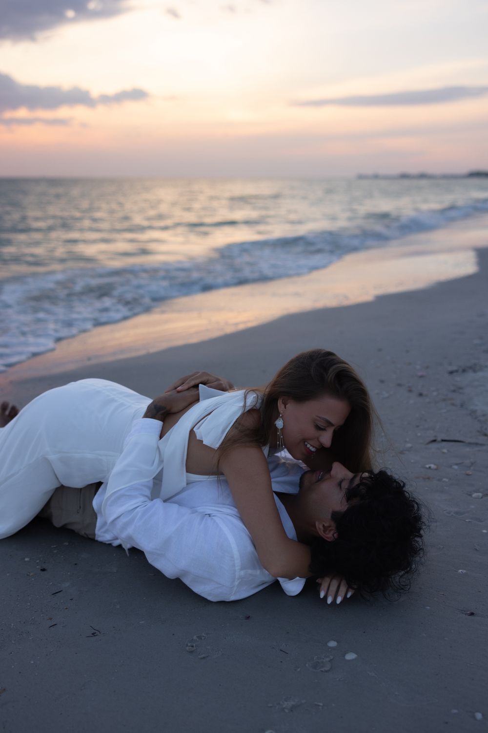 Romantic Couple Embracing on a Beach at Sunset · Free Stock Photo