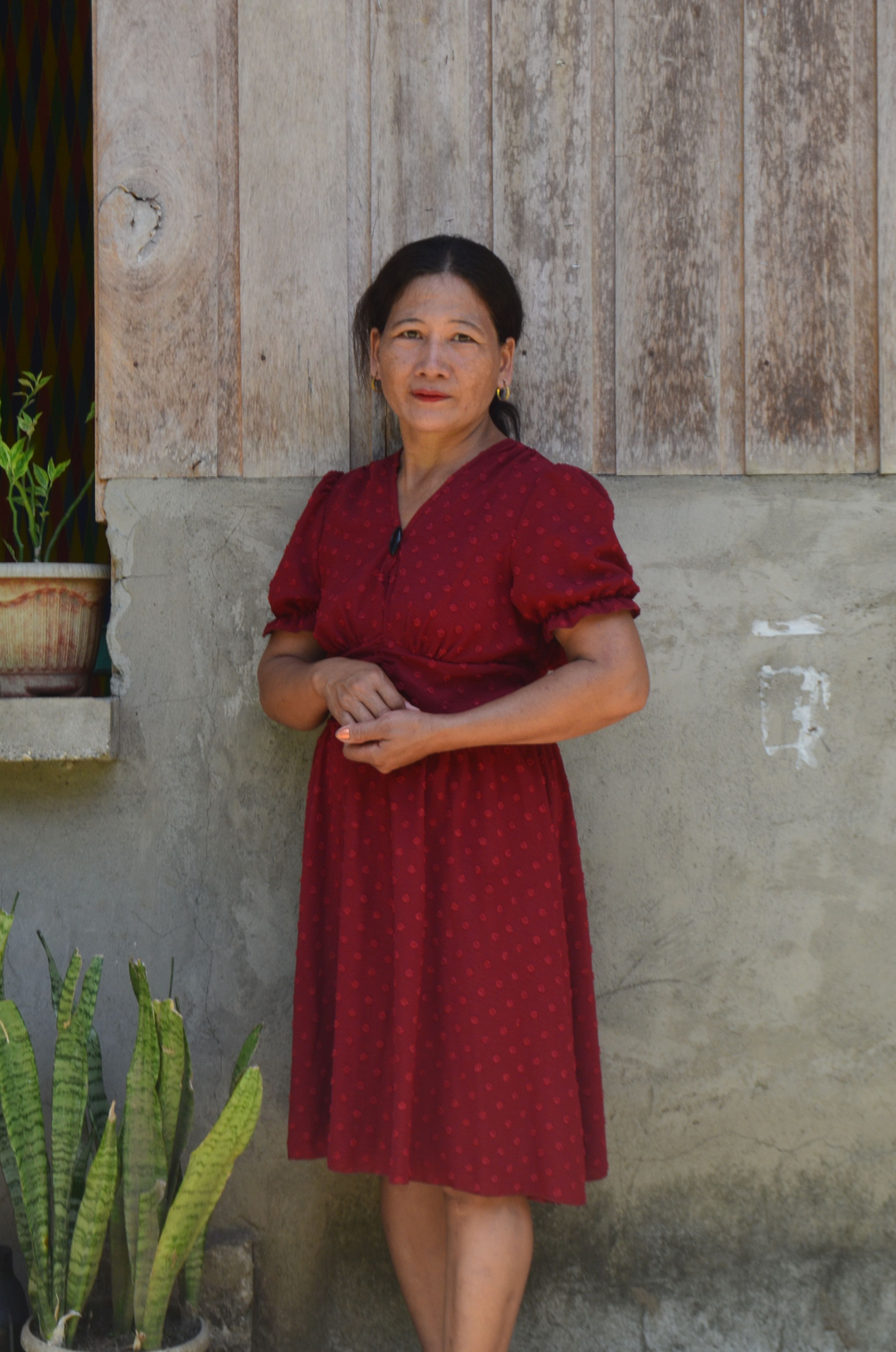 Woman in Red Dress Posing by Rustic Wall · Free Stock Photo