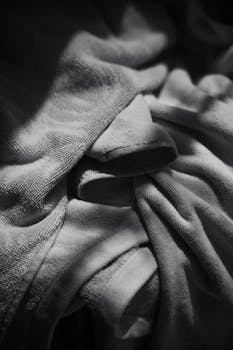 Abstract black and white photo depicting textured towels with dramatic lighting and shadows.