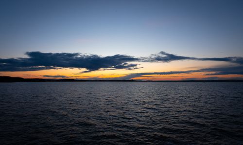 Free Beautiful sunset over a calm lake in Minsk region, Belarus, with vivid orange and blue hues. Stock Photo