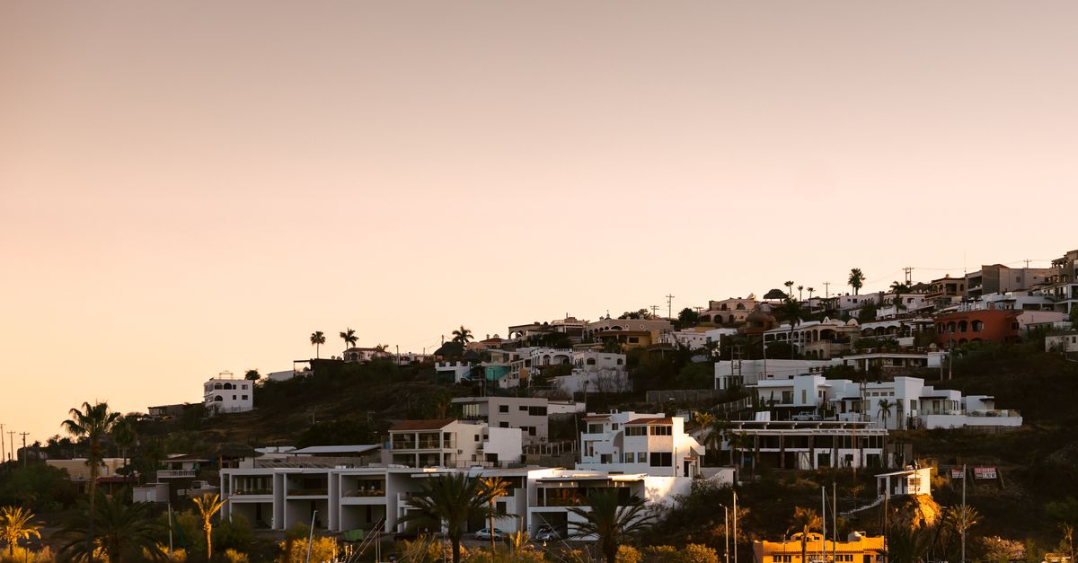 Scenic sunset view of hillside residential area overlooking a marina, serene and picturesque.
