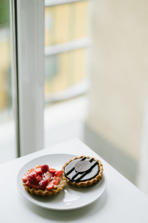 Free Two delectable tarts displayed on a plate, featuring strawberry and chocolate toppings. Stock Photo