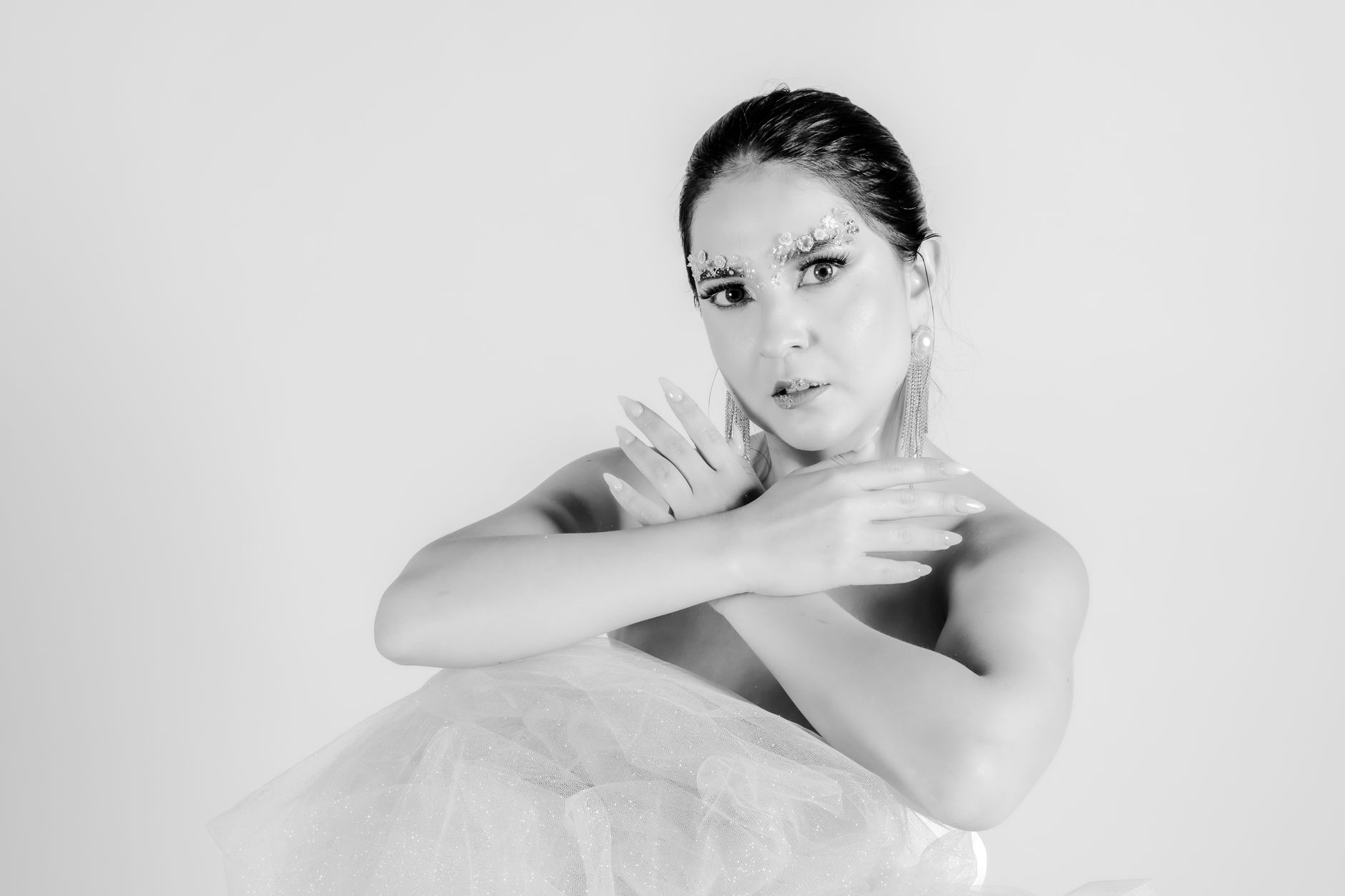 Artistic black and white portrait of a ballerina in an elegant pose, evoking empowerment and grace.