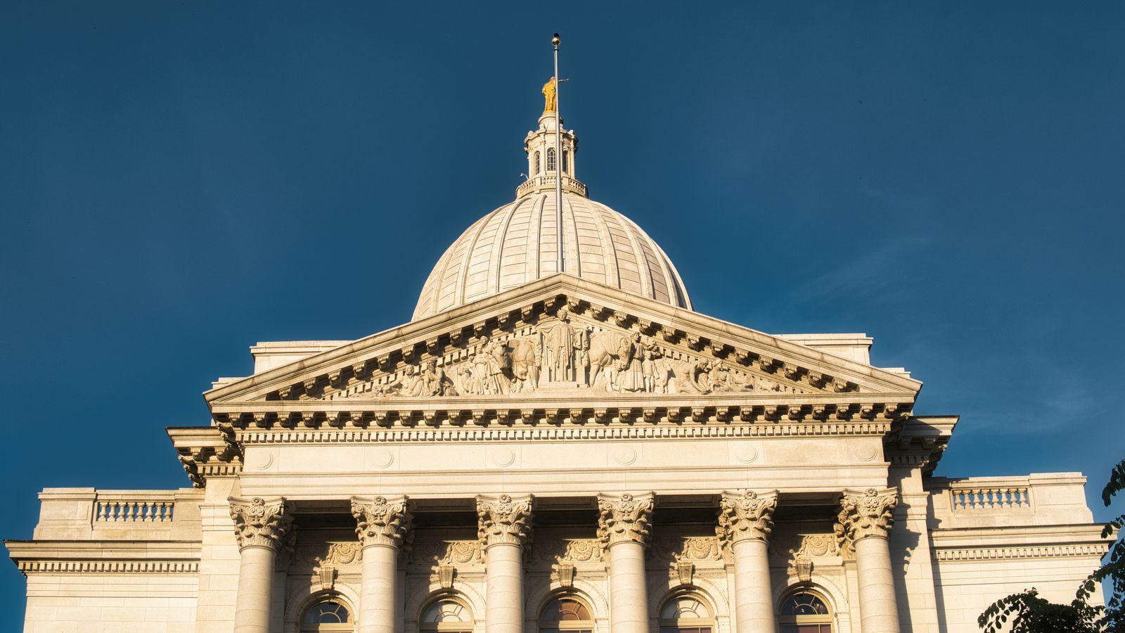 Stunning view of Wisconsin State Capitol building against a clear blue sky in Madison.