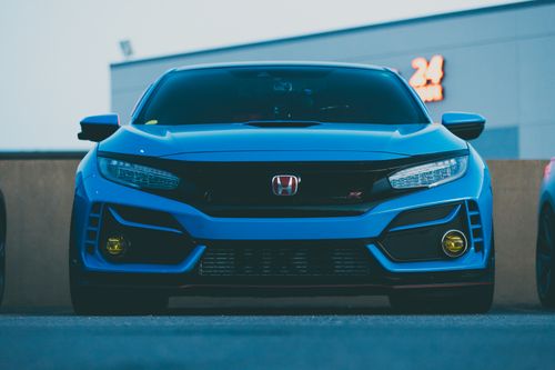 Free Bright Blue Sedan Sitting in Modern City Area Stock Photo