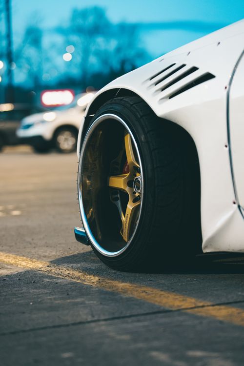 Free Bright Bronze & Chrome Wheel on White Car Stock Photo