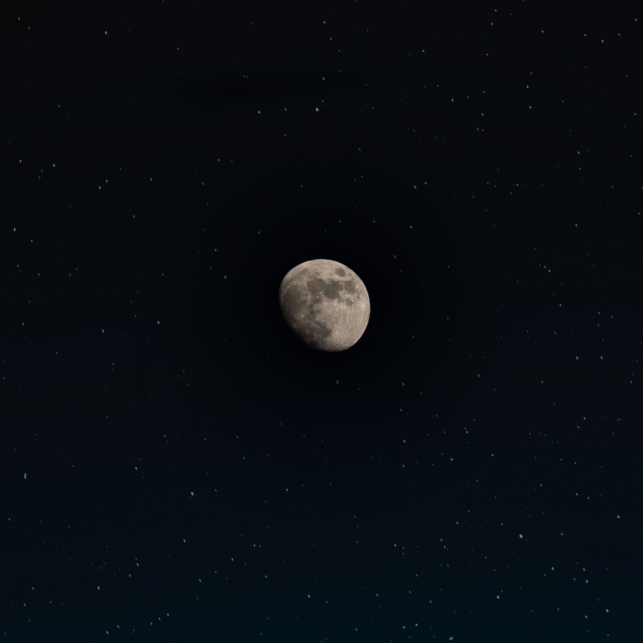 Crescent moon among stars in a night sky — photo by William Hadley on Pexels