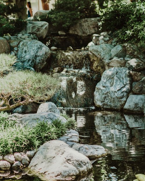 Free Peaceful scene of a Japanese garden in San Diego, featuring a waterfall and lush greenery. Stock Photo