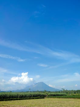 A breathtaking view of a mountain under a clear blue sky in Indonesia, perfect for nature and travel themes.