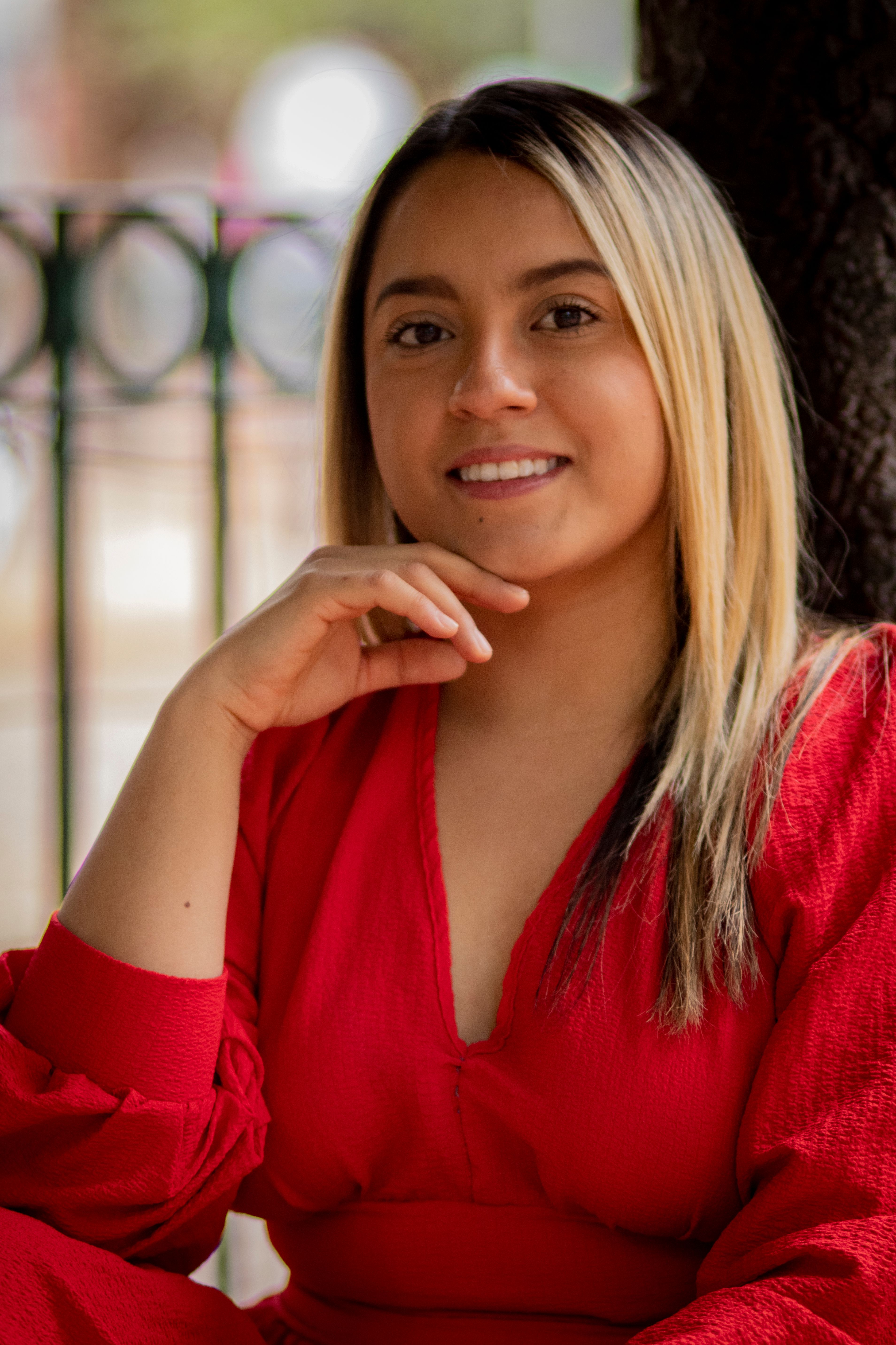 Portrait of a Smiling Woman in Red Dress Outdoors · Free Stock Photo