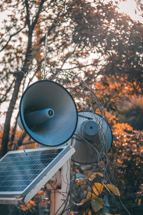 Free Loudspeakers and solar panel in a rural setting with autumn leaves and warm sunlight. Stock Photo