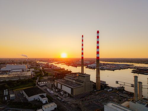 Free A stunning aerial view of Dublin's Poolbeg Chimneys and River Liffey at sunset, capturing the city's industrial and scenic beauty. Stock Photo