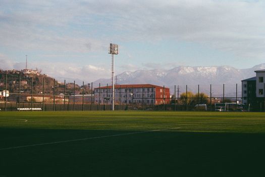 A scenic football field with mountains in the background, captured during daytime.