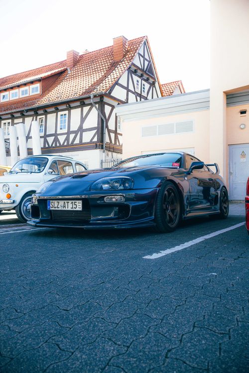 Free A modified sports car showcased at a European car gathering, highlighting automotive culture. Stock Photo