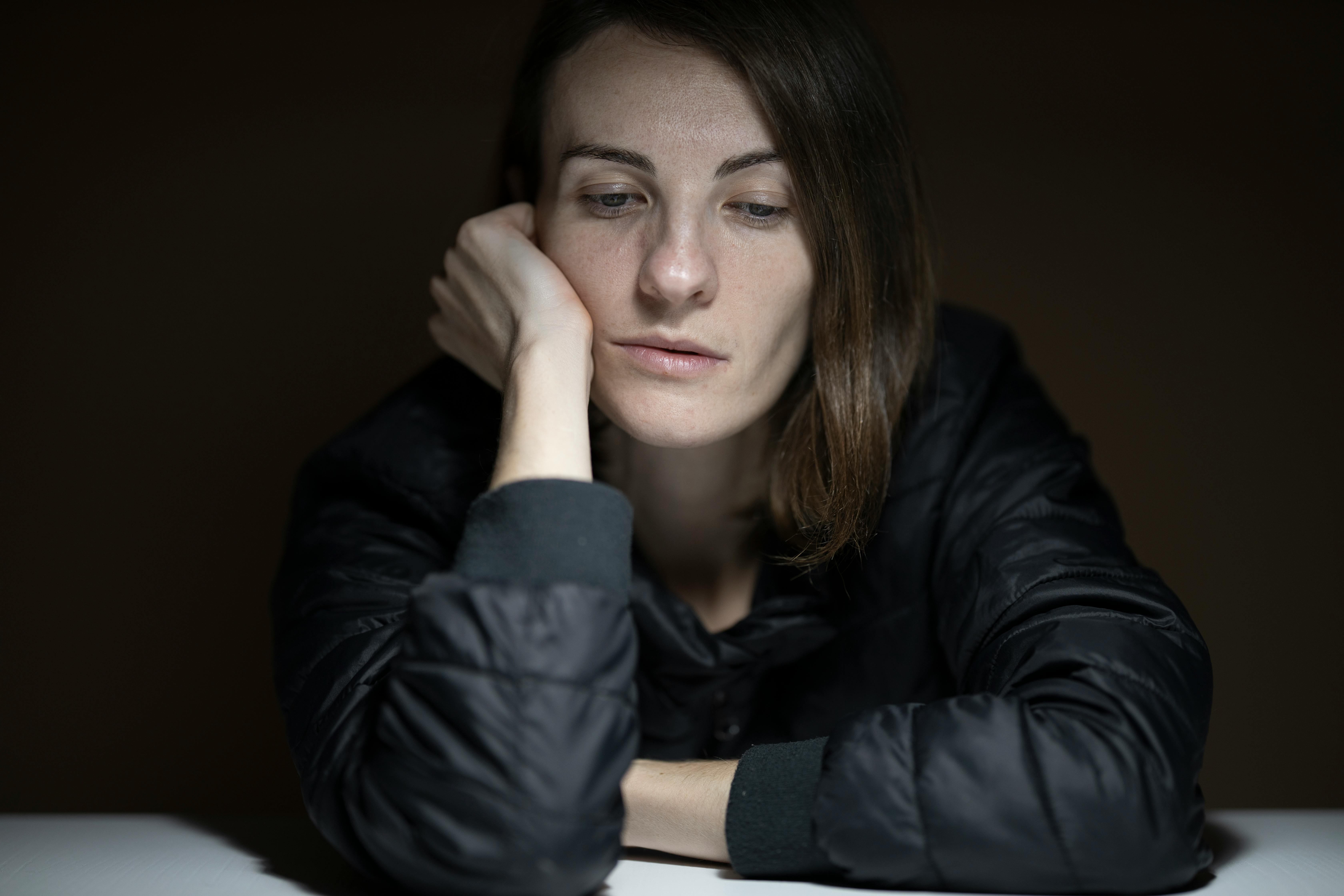 Sad woman in black ensemble. | Photo: Pexels