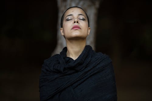 Free Selective Focus Portrait Photo Woman in a Black Shawl Posing With Her Eyes Closed Stock Photo
