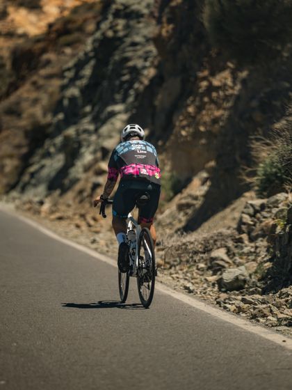 Cyclist climbing a mountain road — photo by kaleef lawal on Pexels