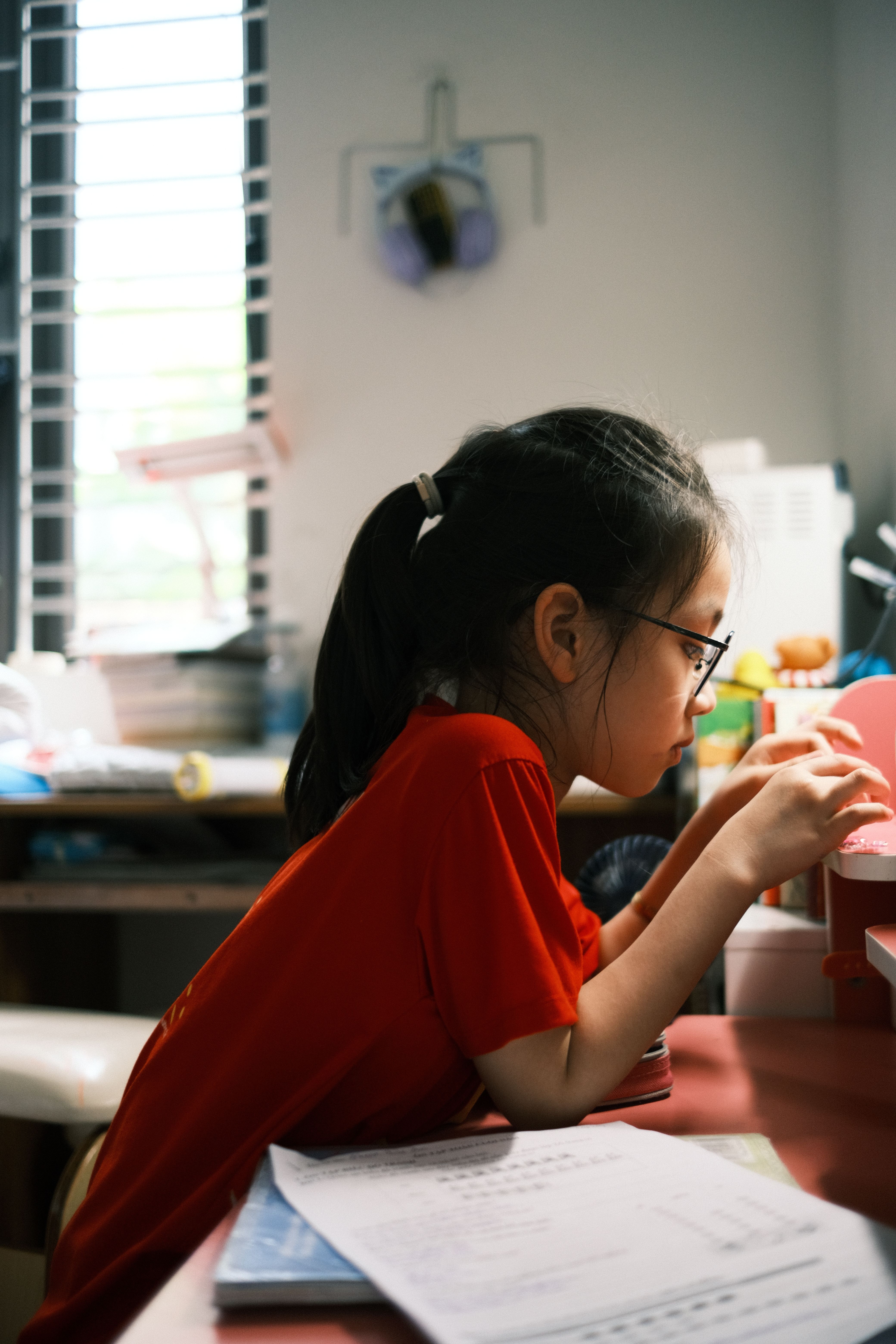Focused Child Studying in Bright Room · Free Stock Photo