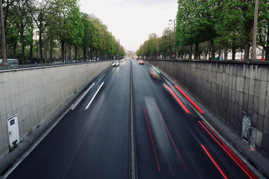 A car approaching a toll booth on a highway outside Paris