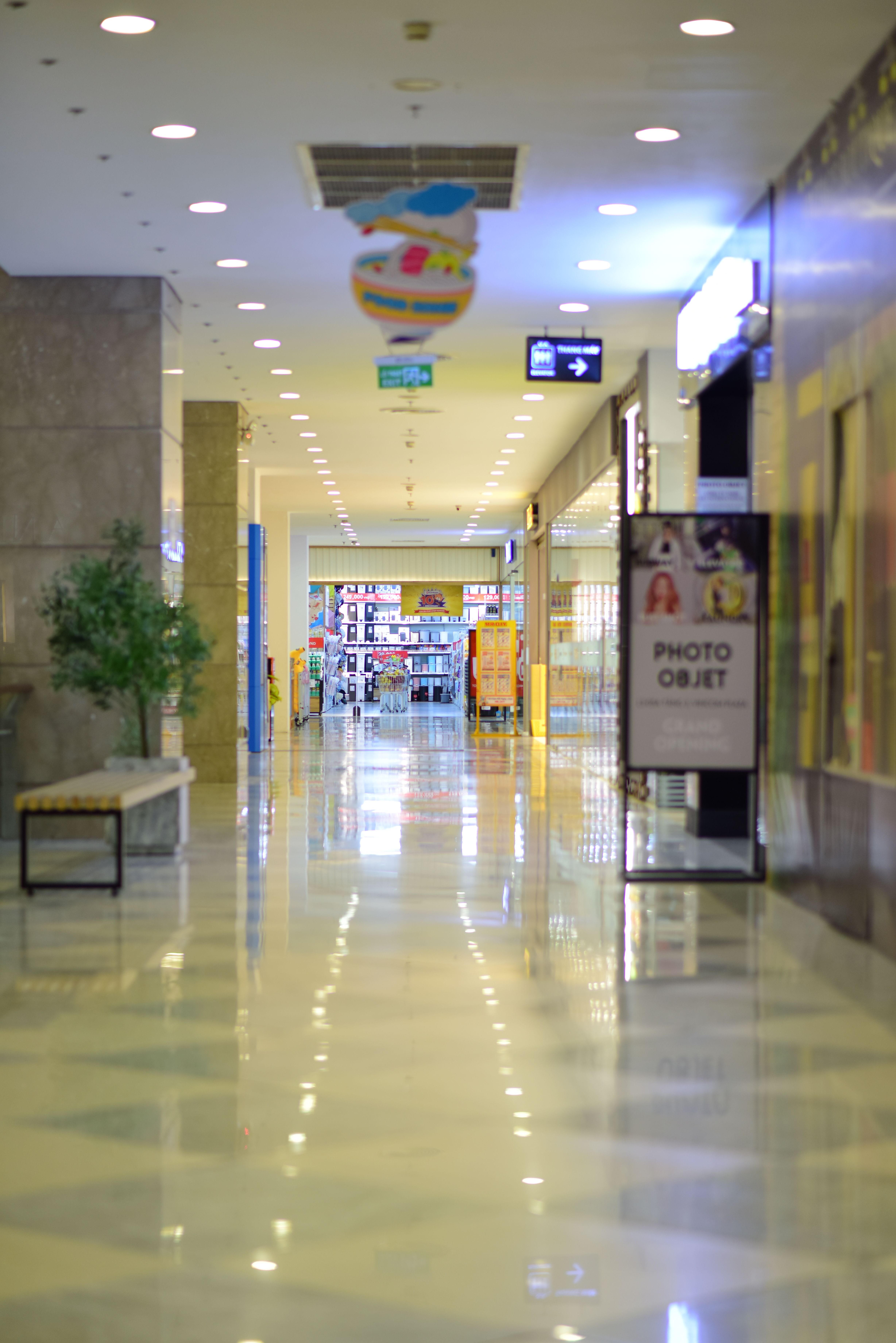 Spacious modern shopping mall interior with retail storefronts
