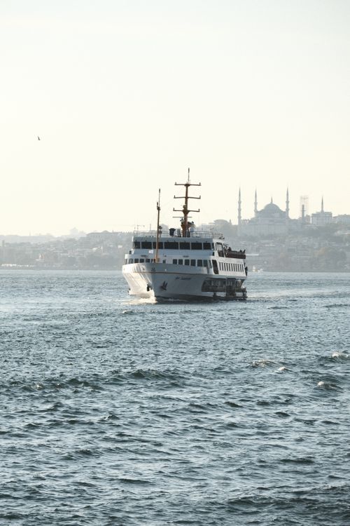 Free A ferry sails across the Bosphorus with Istanbul's skyline and mosques in the background. Stock Photo