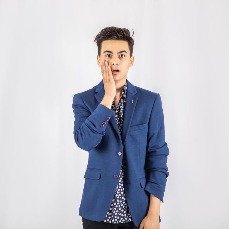 Free Photo of Shocked Man in Blue Blazer Standing In Front of White Background Stock Photo