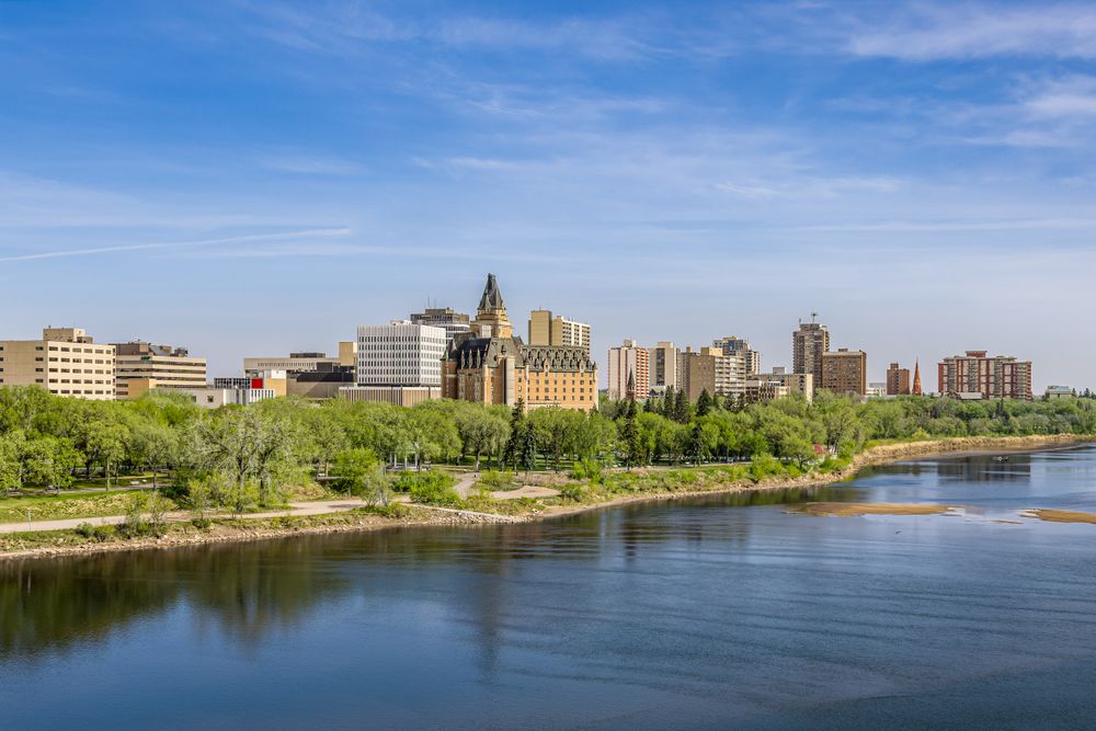 A beautiful spring view of Saskatoon cityscape with a river and reflections.