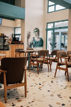 Trendy café interior featuring artistic wall mural and stylish furniture.