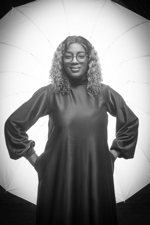 Free Black and white portrait of a confident woman in front of studio umbrella lighting. Stock Photo