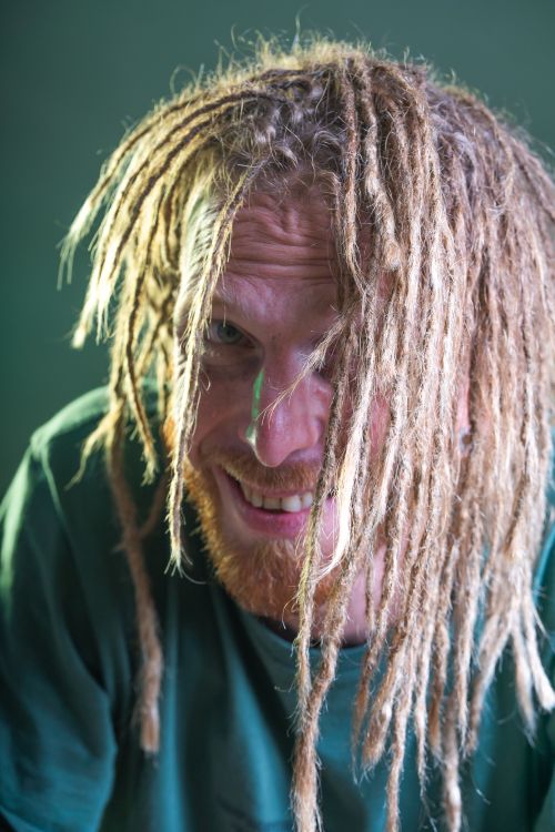 Free Close-up portrait of a bearded man with dreadlocks and a joyful smile. Stock Photo