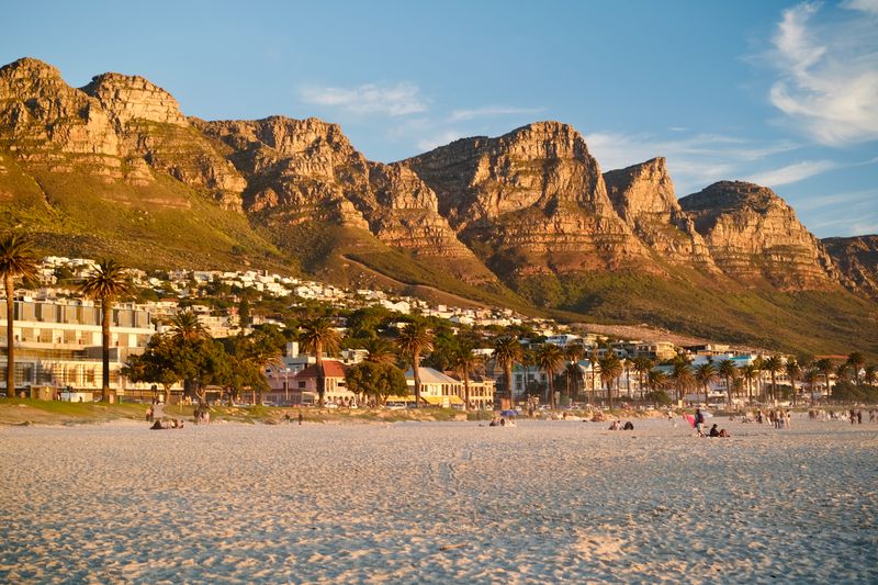 Camps Bay beach with the Twelve Apostles mountains in Cape Town