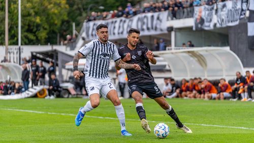 Free Two soccer players in action during a competitive match outdoors. Stock Photo