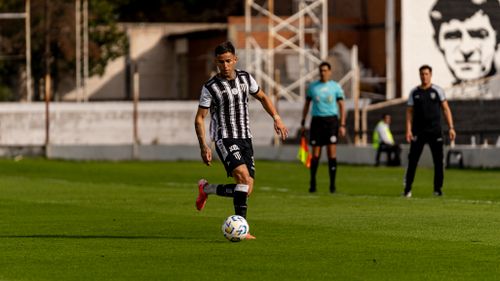 Free Soccer player dribbling the ball during a daytime outdoor match. Stock Photo