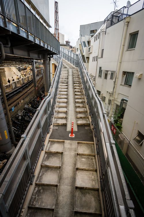 Free Concrete stairway in a bustling Japanese cityscape with modern architecture. Stock Photo