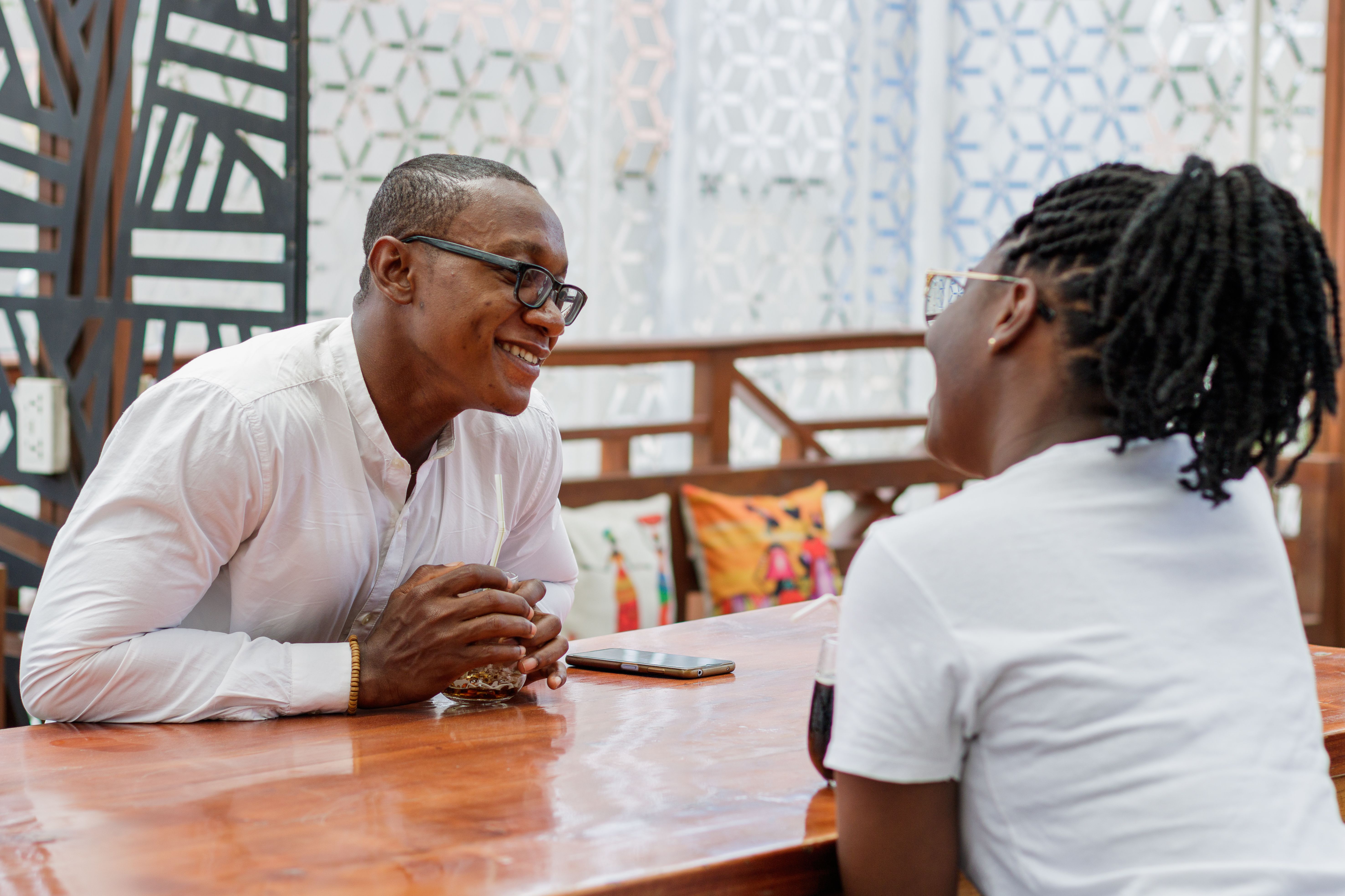 A joyful couple engaging in a heartfelt conversation at a vibrant restaurant.