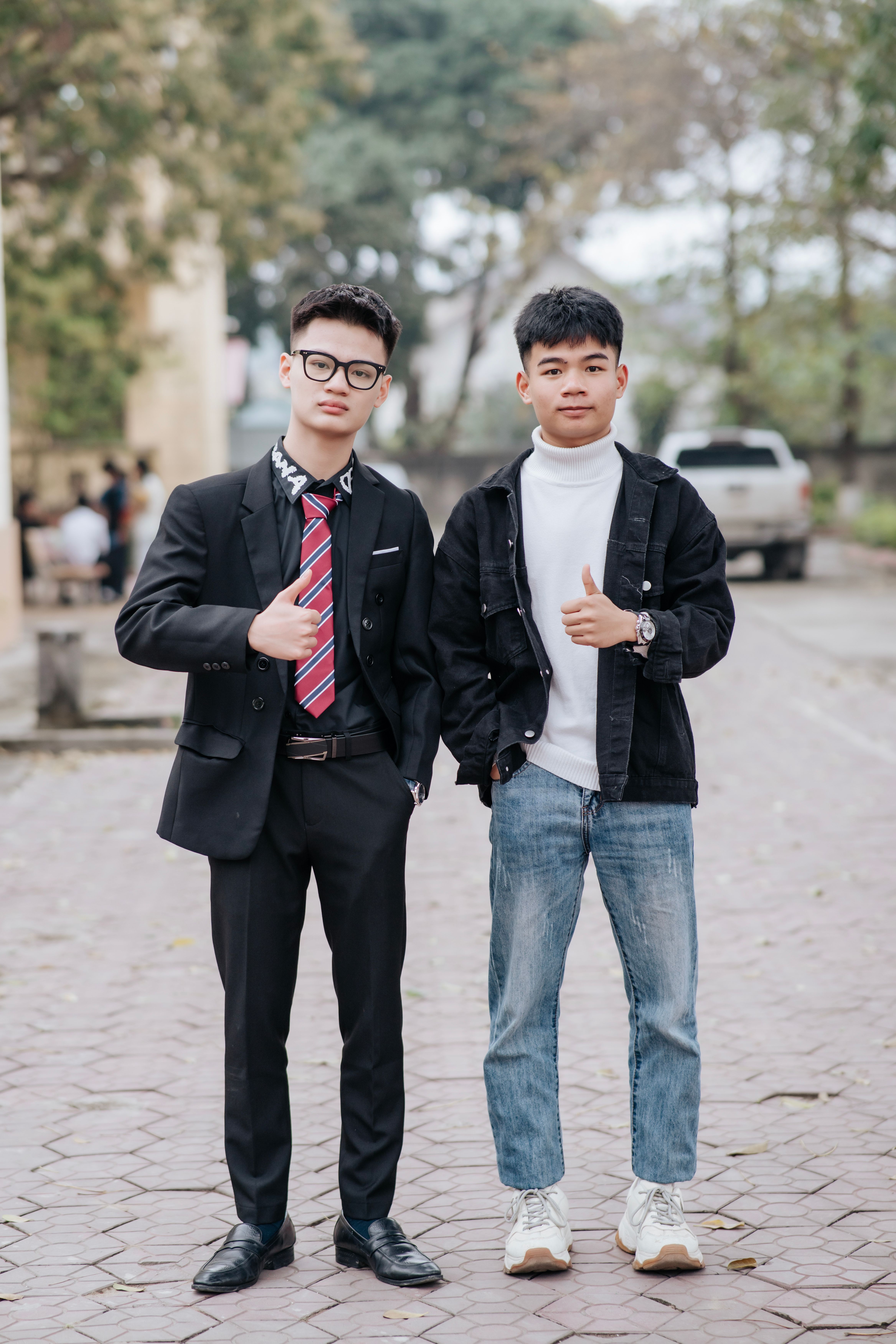 Two Young Men in Casual and Formal Attire Outdoors · Free Stock Photo