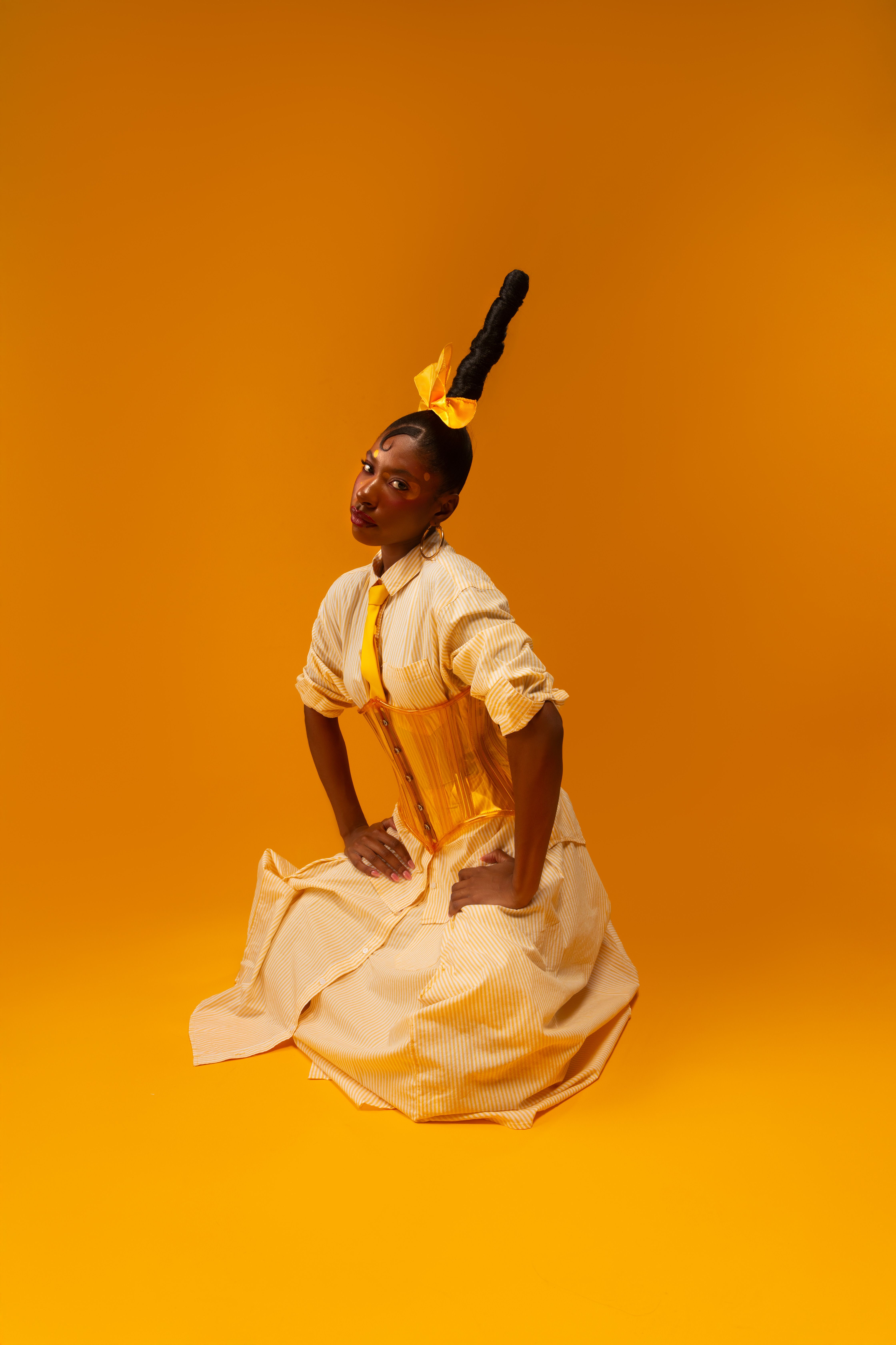 Fashion editorial portrait in a bright yellow dress