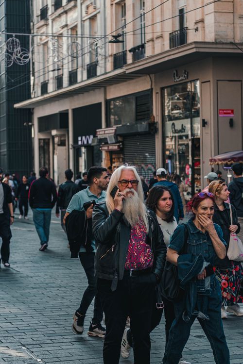 Free Crowd walking along Istiklal Avenue in Istanbul, featuring a stylish elderly man. Stock Photo