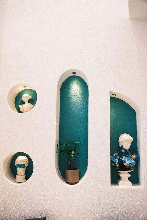 Free Artistic wall with stylish sculptures and potted plant in a modern setting. Stock Photo